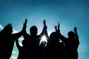 People worshipping arms lifted up